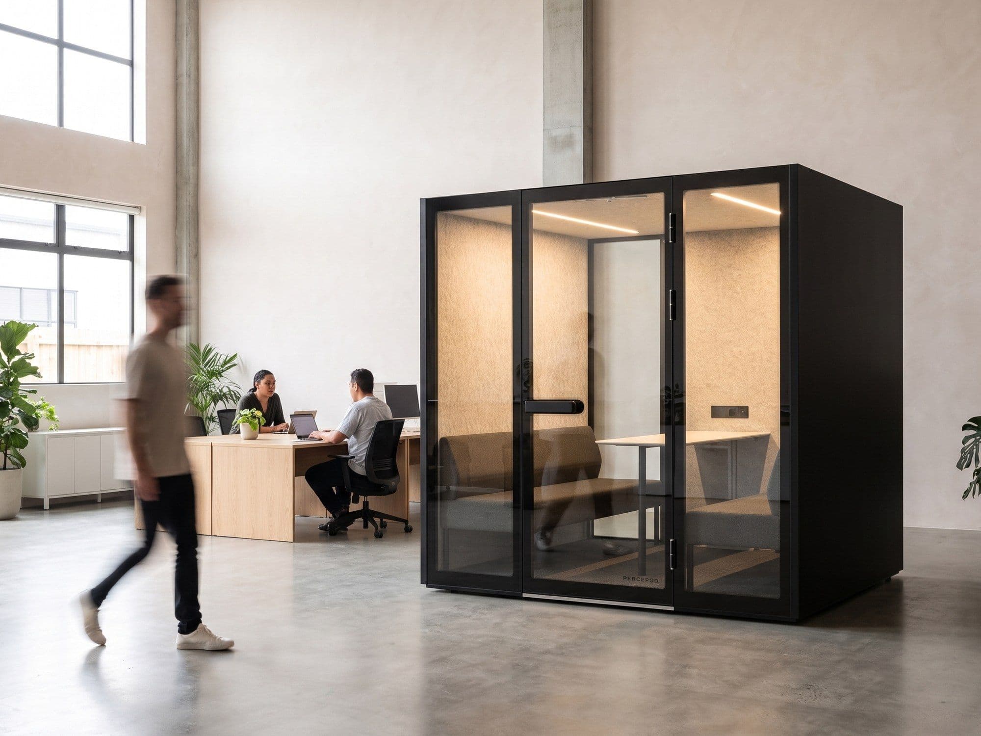 A Peacepod meeting pod in a bright open-plan office